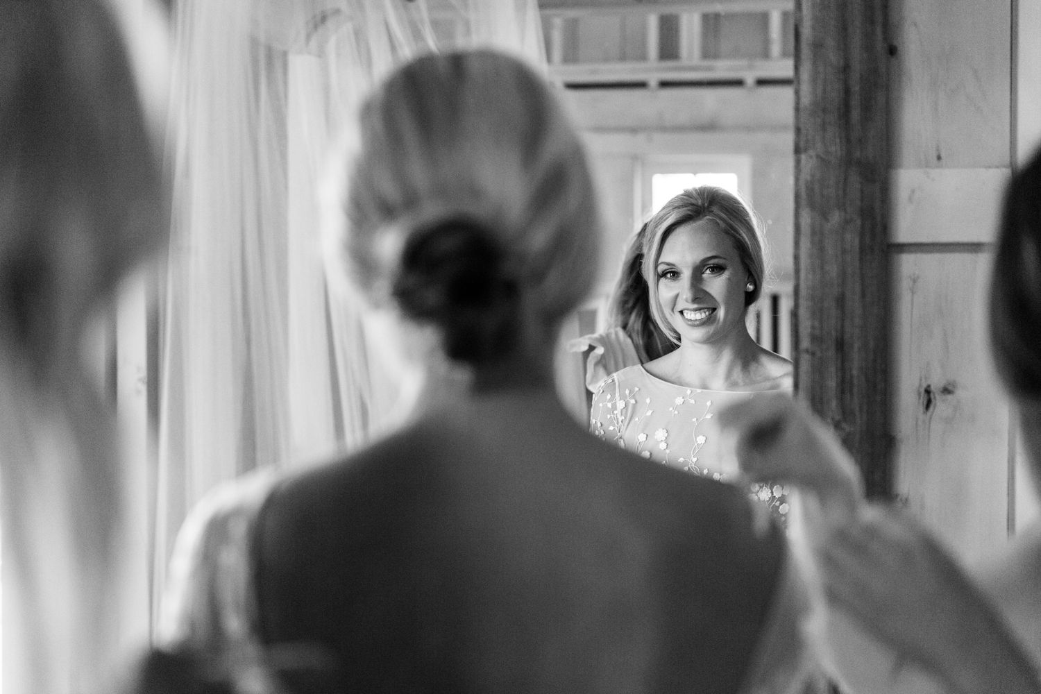 Black and white candid moments during wedding preparations in a sunlit room.