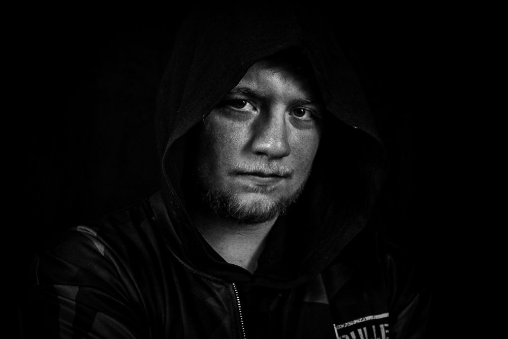 Dark atmospheric portraits with dramatic shadows and lighting effects.