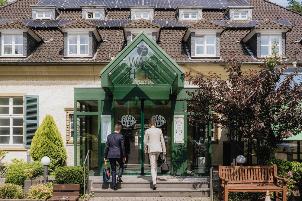 Classic building entrance with green glass canopy and ornate architecture.