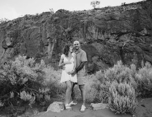 Black and white photography series showing people exploring arid desert landscape with sagebrush and rocky terrain.