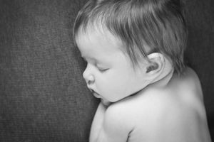 Series of black and white portraits showing a sleeping baby's profile.