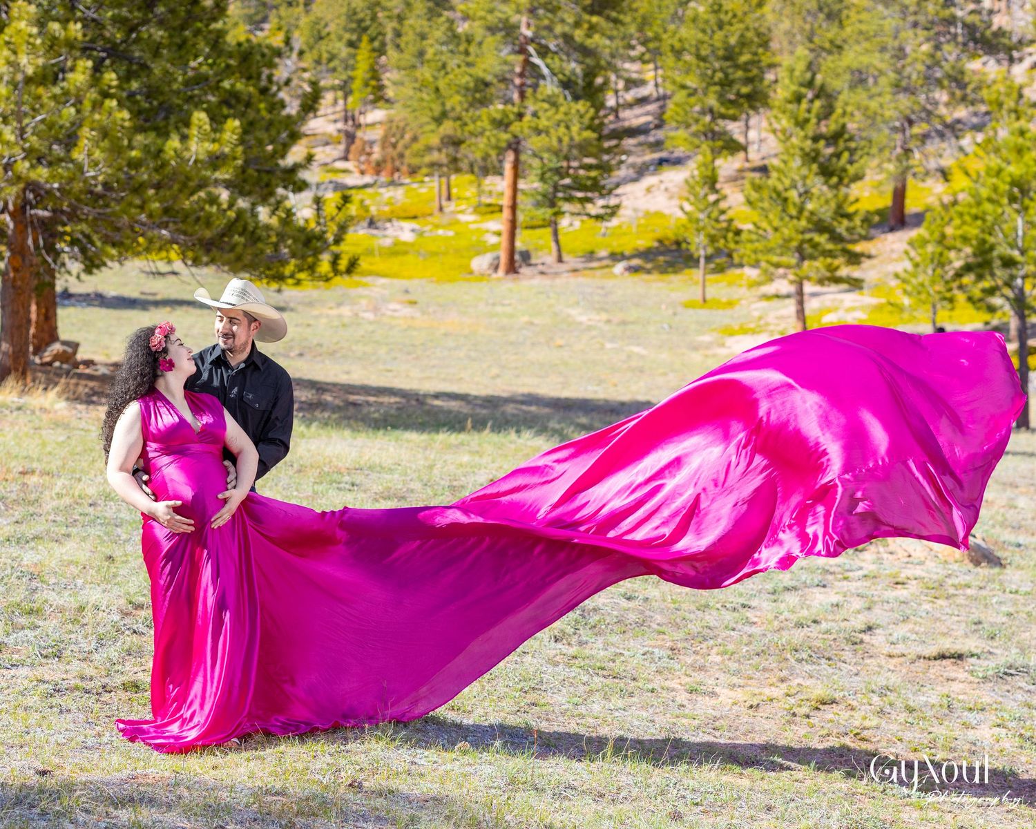 A bright pink silk fabric flows elegantly across a rocky outdoor landscape in a dynamic motion capture sequence.