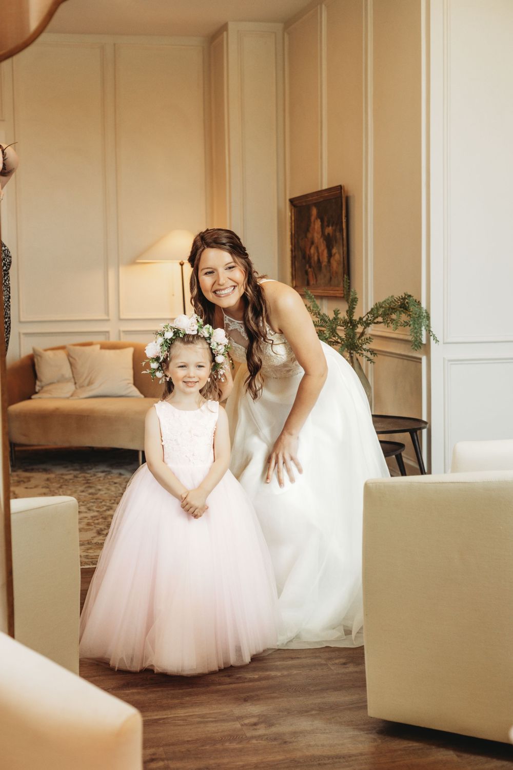 Sweet moment captured in an elegant white room with tulle dresses.