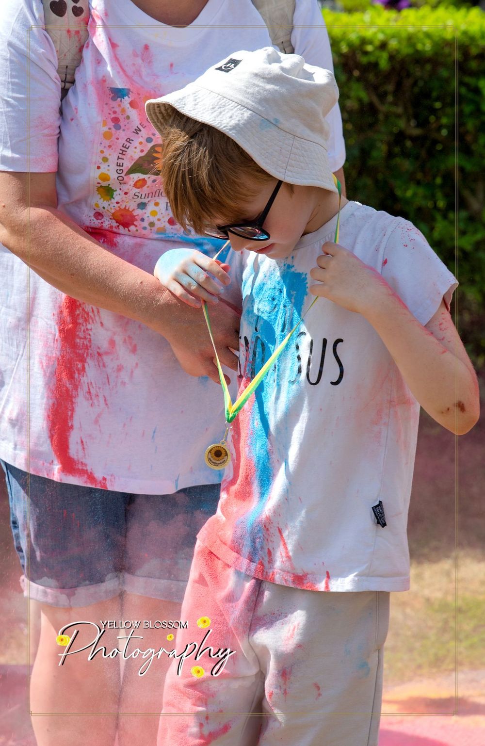 Close-up of powder-covered participants enjoying a colorful festival activity.