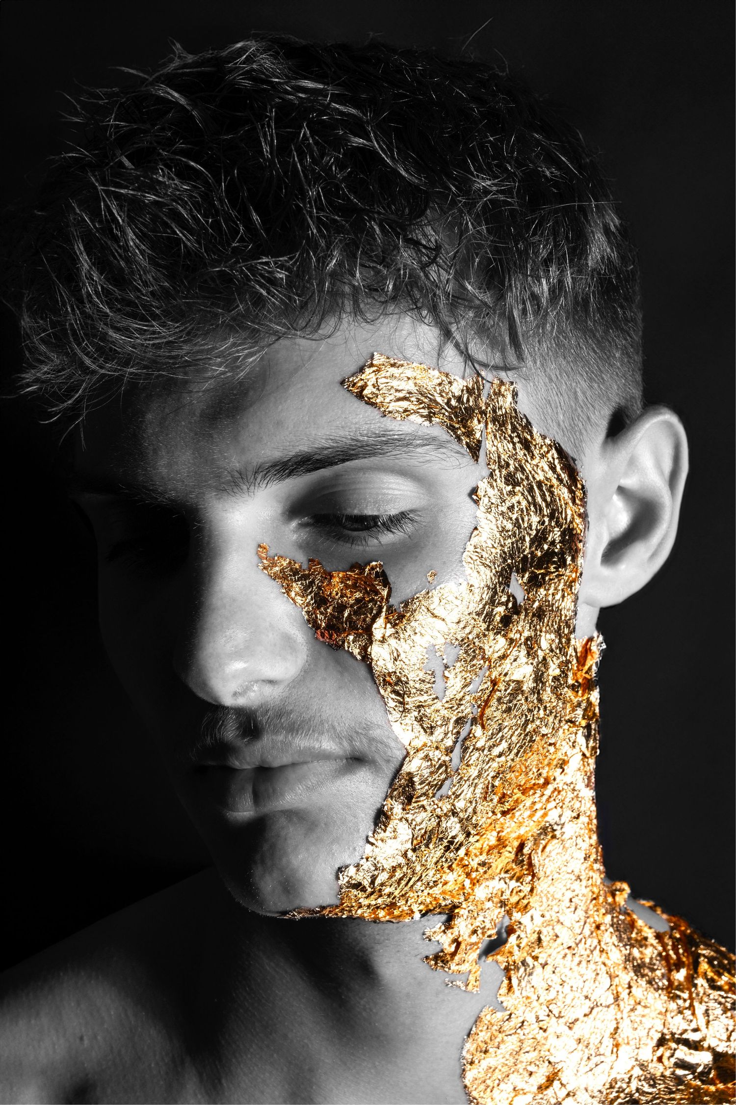 Artistic black and white photograph with gold metallic texture overlay on side profile.