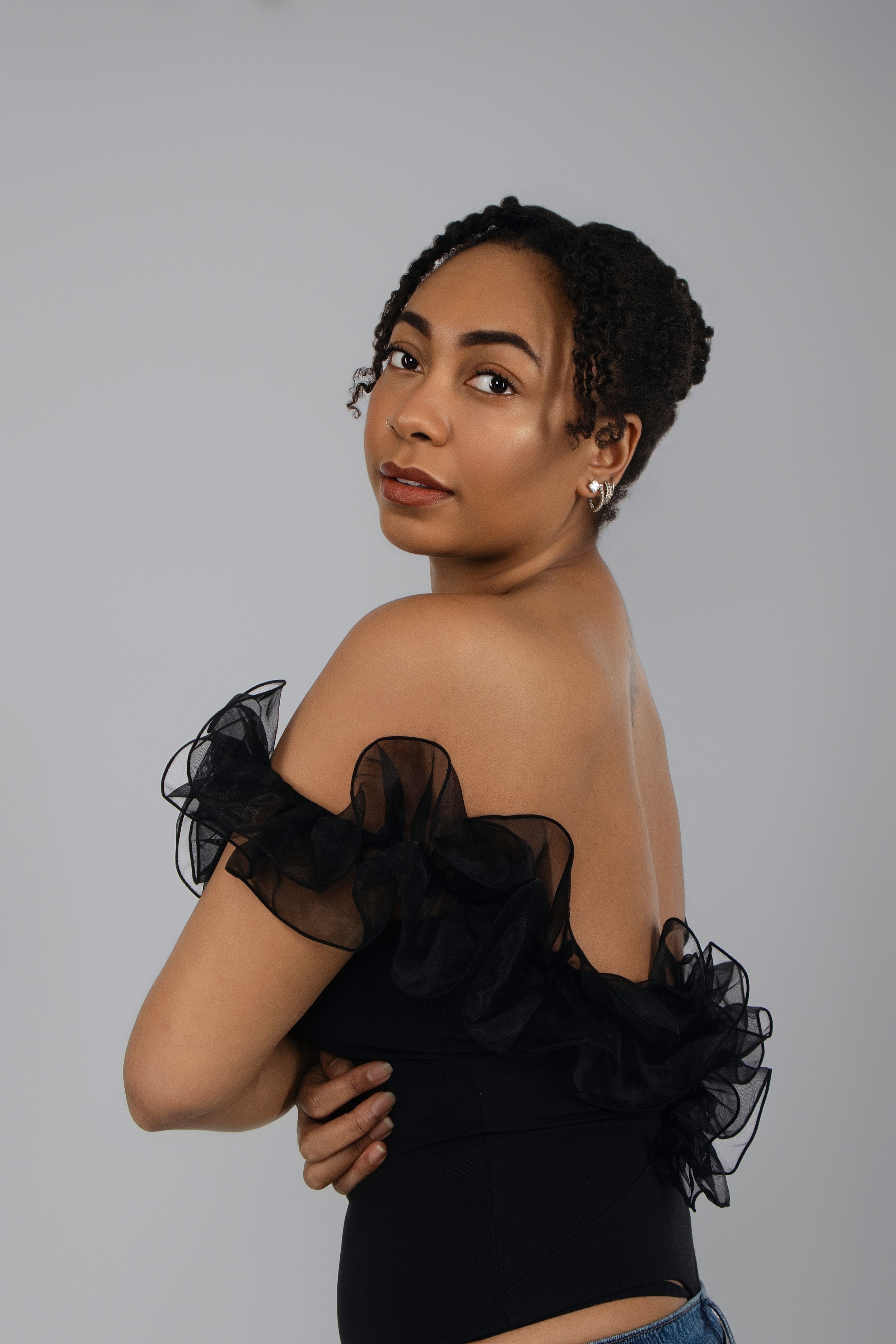 Artistic portrait series in black ruffled dress showing various elegant poses.