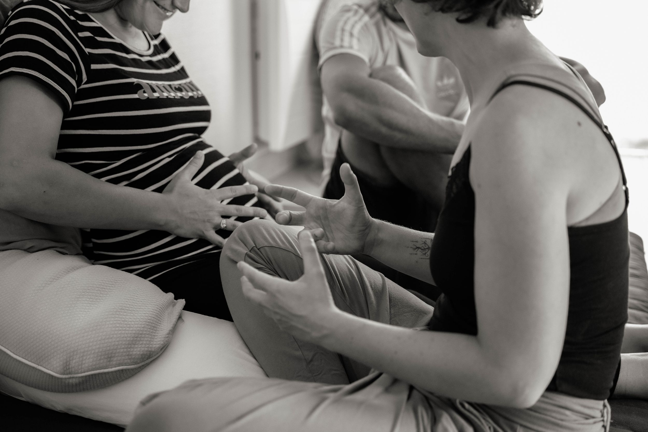 Black and white photos showing hands playing a game of dominoes on a wooden table.