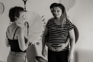 A black and white photo series showing people in striped shirts dancing and moving together in a casual setting.