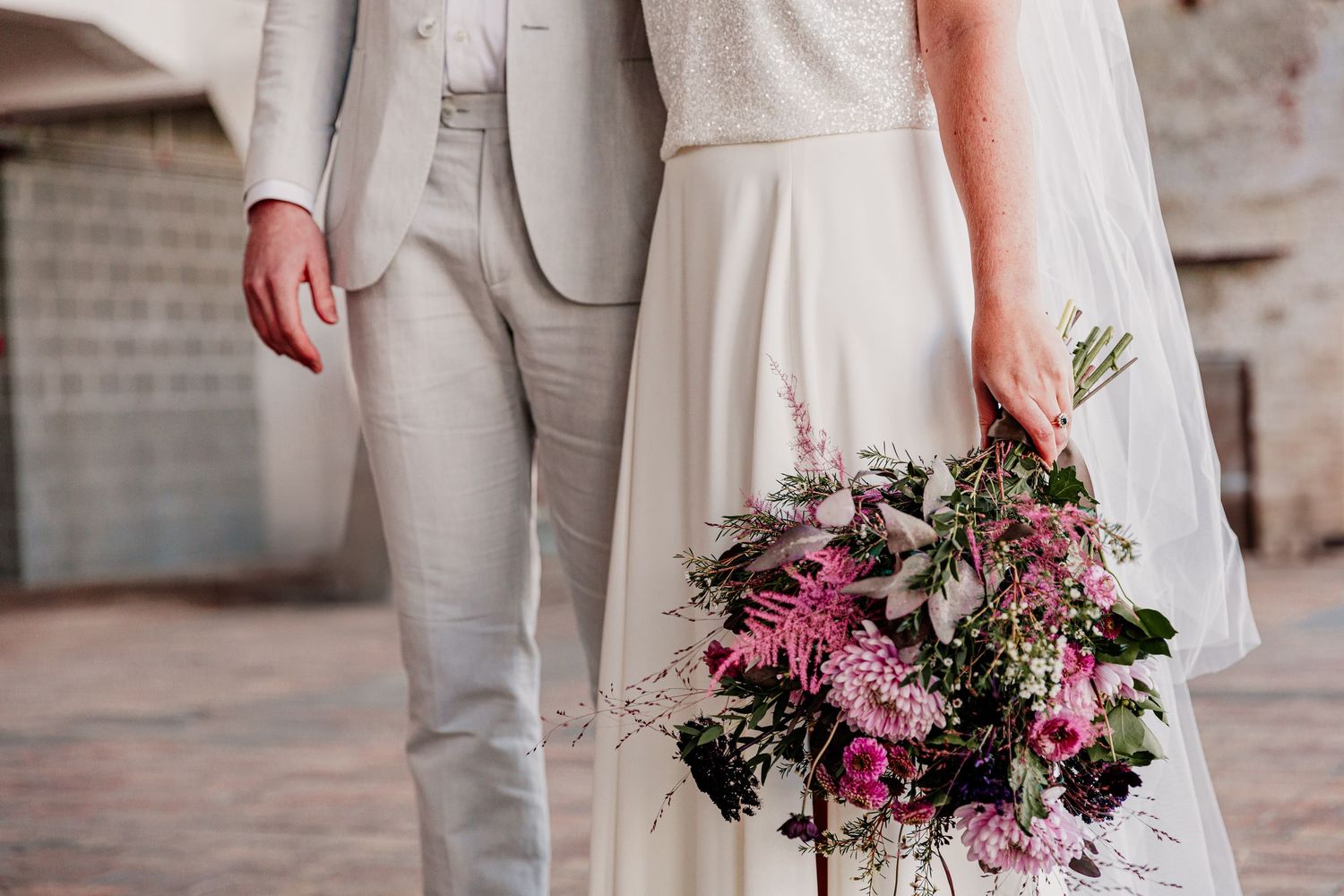 Elegant wedding ceremony details with pink floral arrangements and light neutral decor elements.