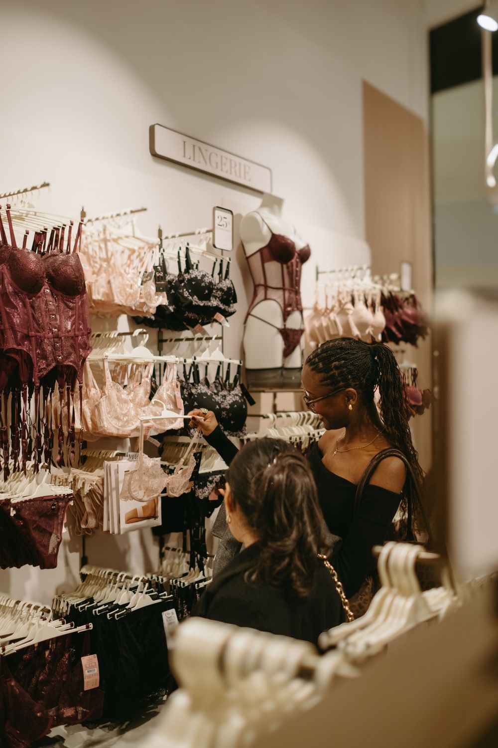 women looking at underwear pieces during store launch event while being captured by fashion brand event photographer in Stockholm