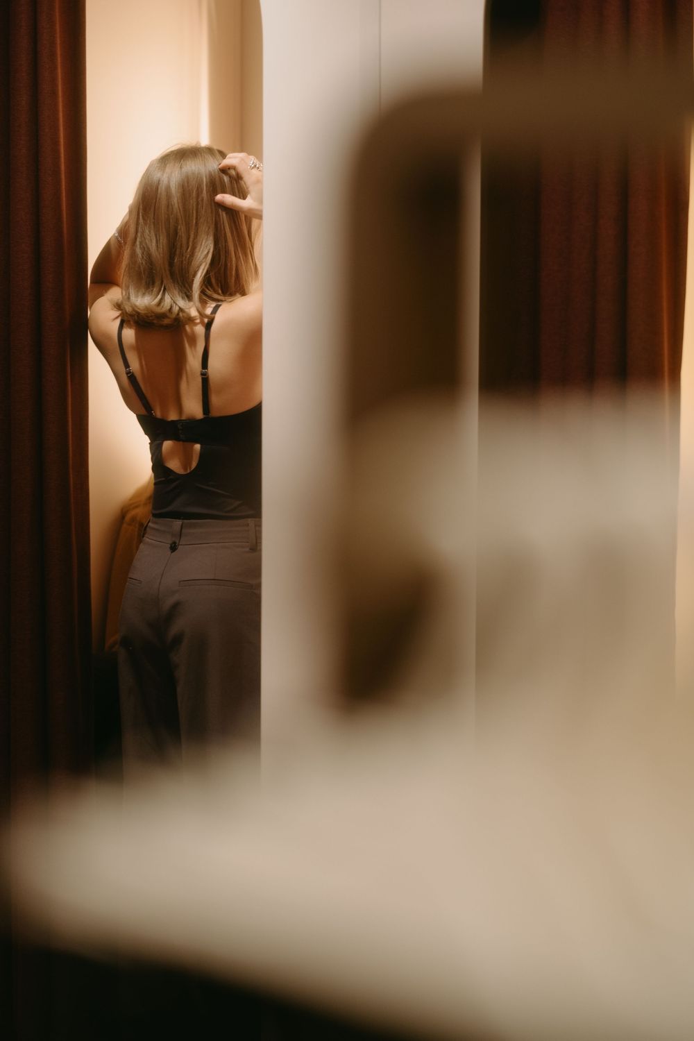 girl trying on a top at a store during retail brand event while being captured by marketing brand event photographer in Stockholm