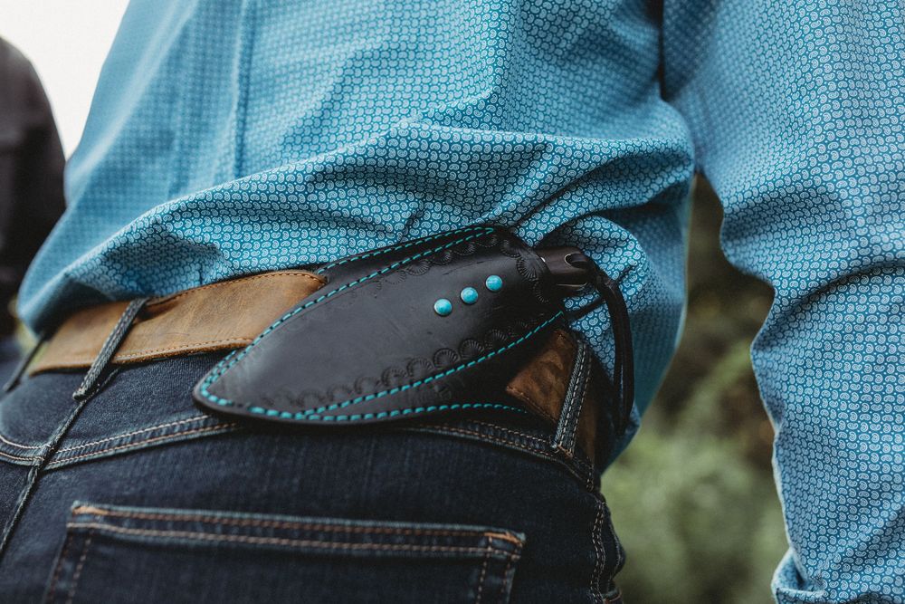 Close-up view of blue denim jeans with detailed stitching and pocket design.