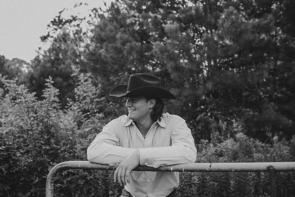 A series of black and white photos showing someone in a cowboy hat sitting on a fence in a rural setting.