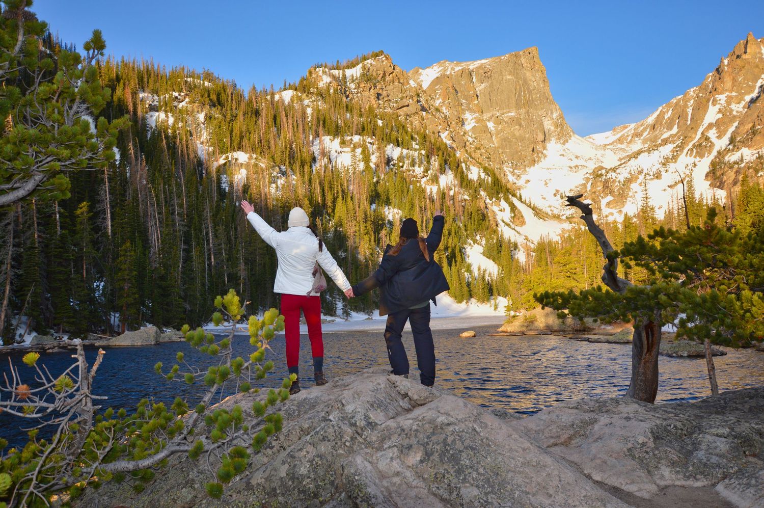She holds her hand and raise their arms in celebration of just getting engaged. The Dream Lake Proposal was beautiful! Pixcapades