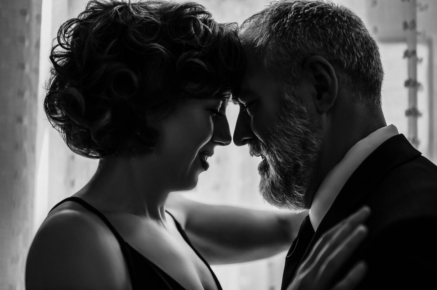 Black and white photo of a romantic couple leaning foreheads together in an intimate moment.  boudoir photos for couples