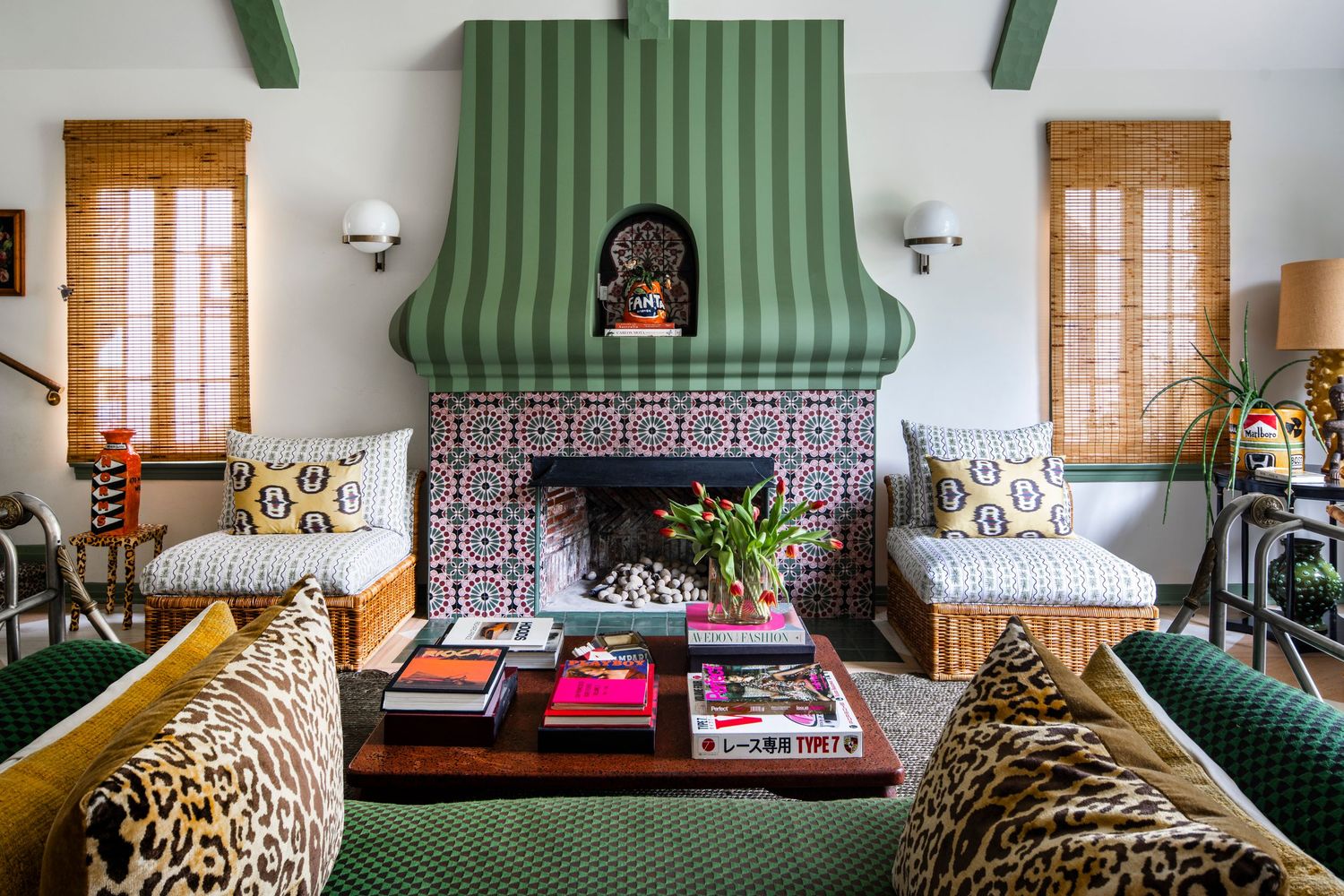 Eclectic living room with green striped fireplace hood, mosaic tile surround, leopard print chairs, and colorful throw pillows.