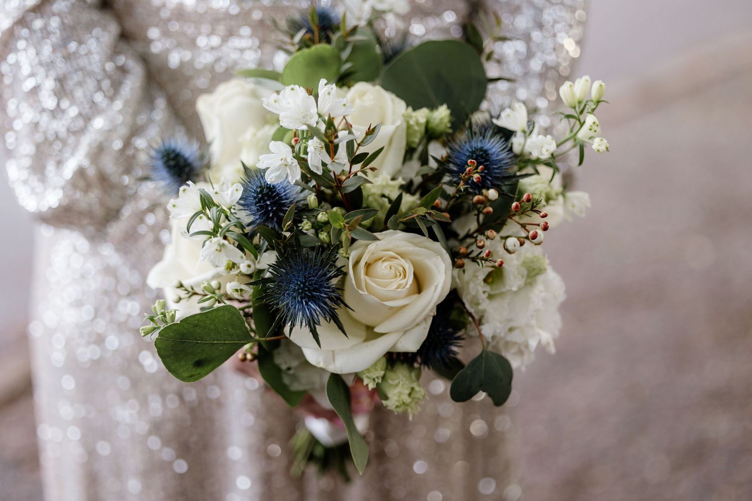 Bridal bouquet with roses and thistles