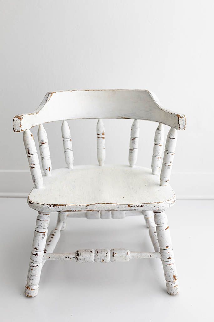 Distressed white painted vintage wooden armchair, baby photographer in Lake Elsinore, California.