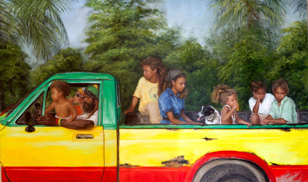 Children riding in the back of a colorful yellow and red pickup truck surrounded by tropical green trees.