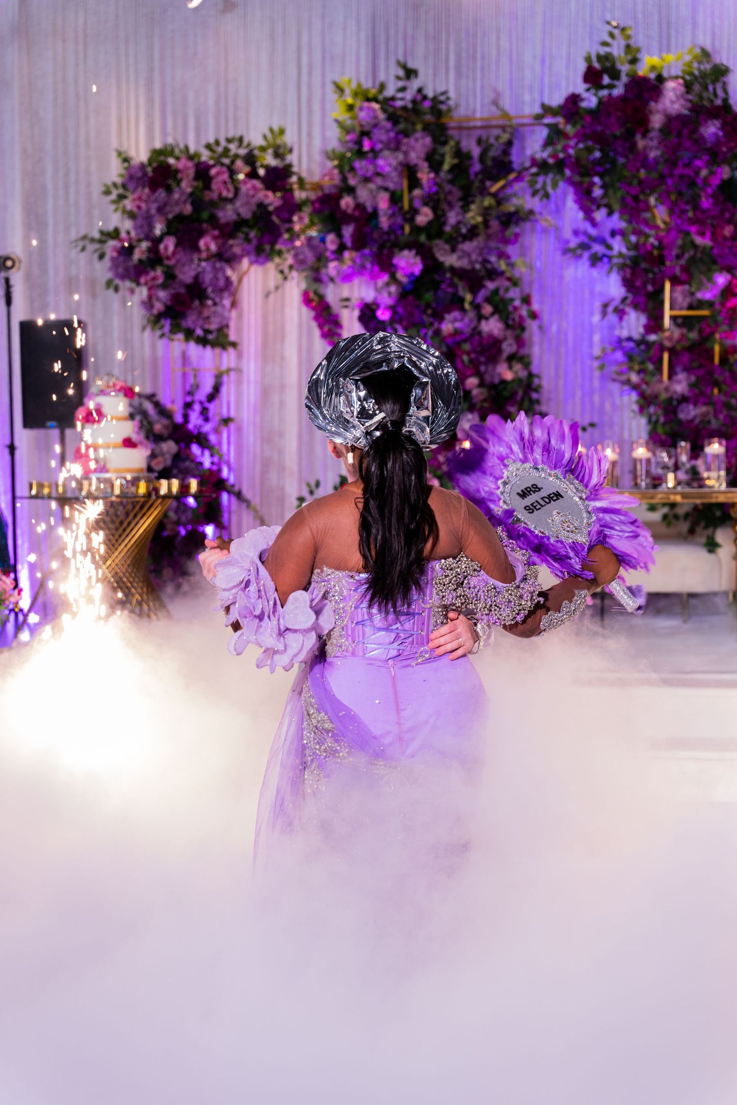 Wedding reception venue with purple lighting and fog effects on dance floor.