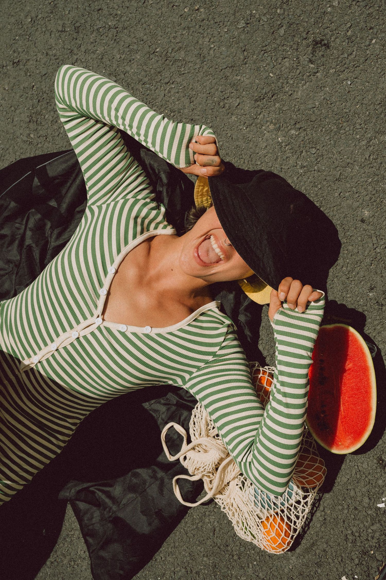 Model playing with fresh oranges at a Saigon street market — vibrant editorial portrait photography by Anastasia Sokyrka