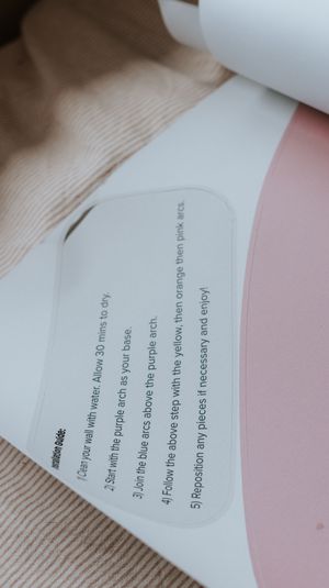 Close-up of wall decal application instructions showing 5 steps for applying colorful arch stickers to a wall.