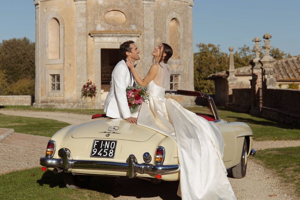 Bride and groom walking through the gardens of Castello di Celsa during a wedding in Tuscany, captured by a wedding photographer Tuscany.