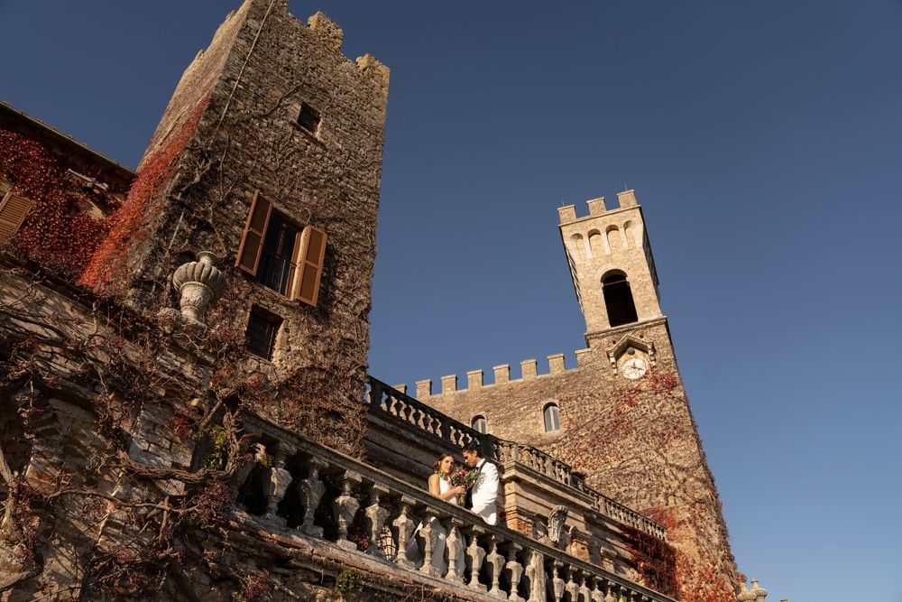 Bride and groom walking through the gardens of Castello di Celsa during a wedding in Tuscany, captured by a wedding photographer Tuscany.