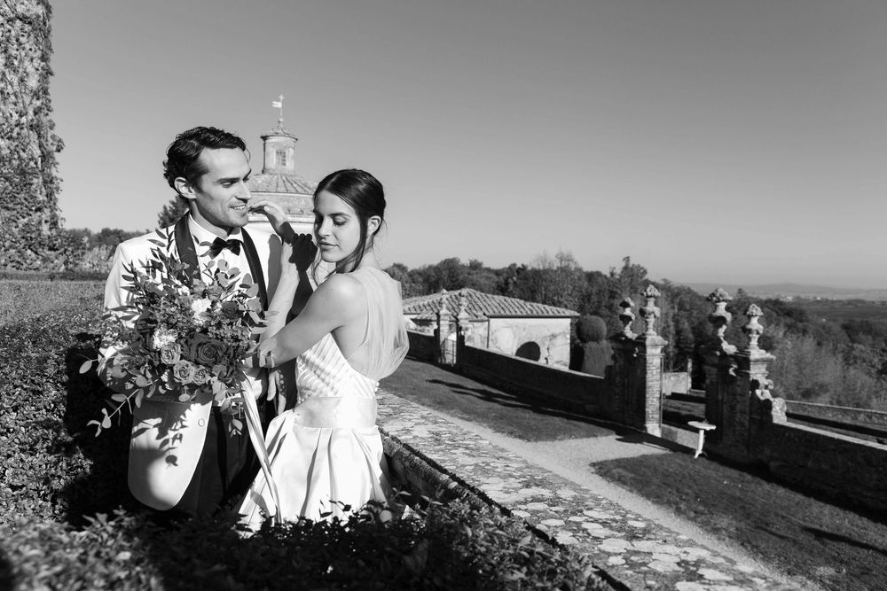 Bride and groom walking through the gardens of Castello di Celsa during a wedding in Tuscany, captured by a wedding photographer Tuscany.