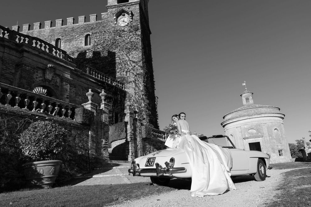 Bride and groom walking through the gardens of Castello di Celsa during a wedding in Tuscany, captured by a wedding photographer Tuscany.