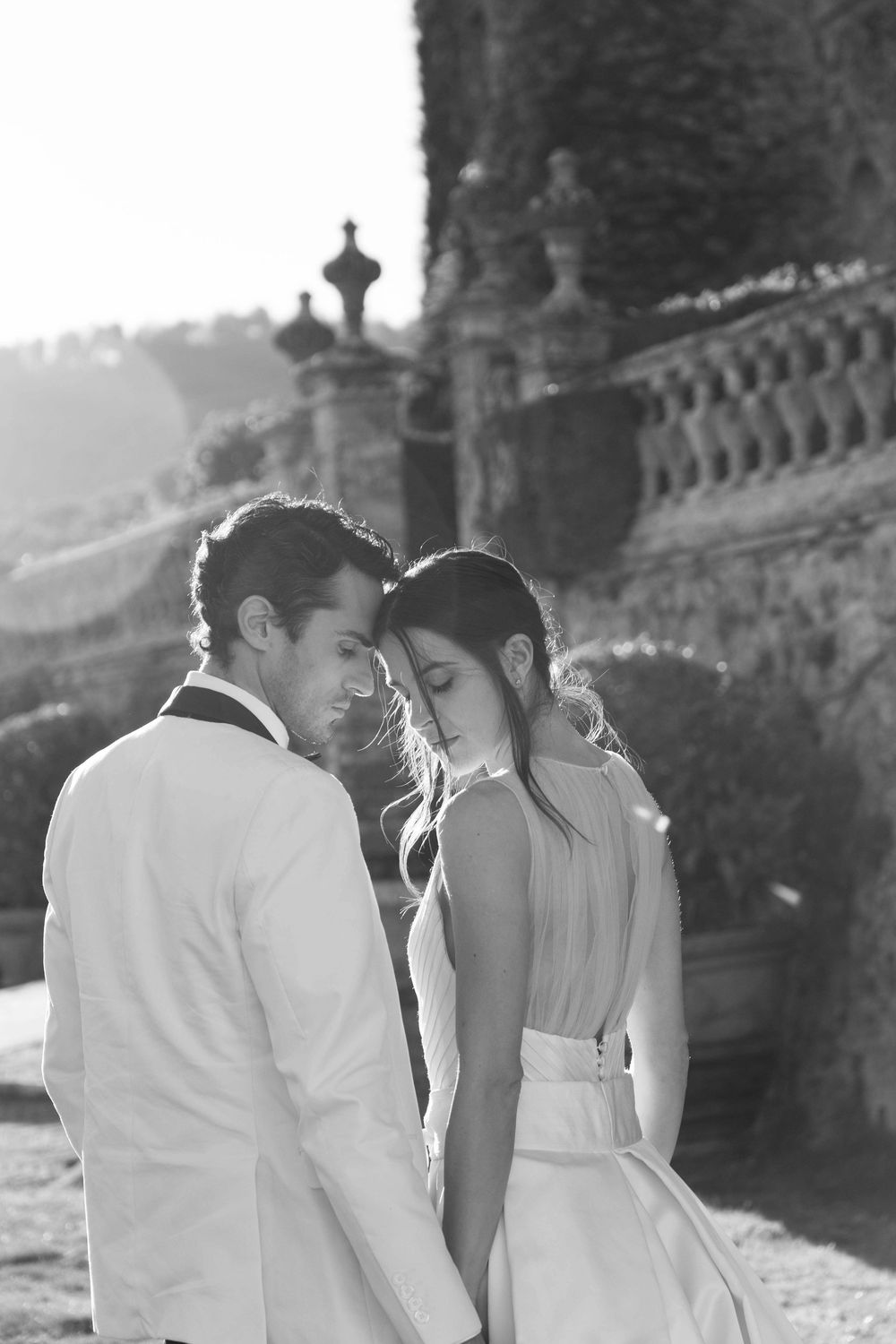 Bride and groom walking through the gardens of Castello di Celsa during a wedding in Tuscany, captured by a wedding photographer Tuscany.
