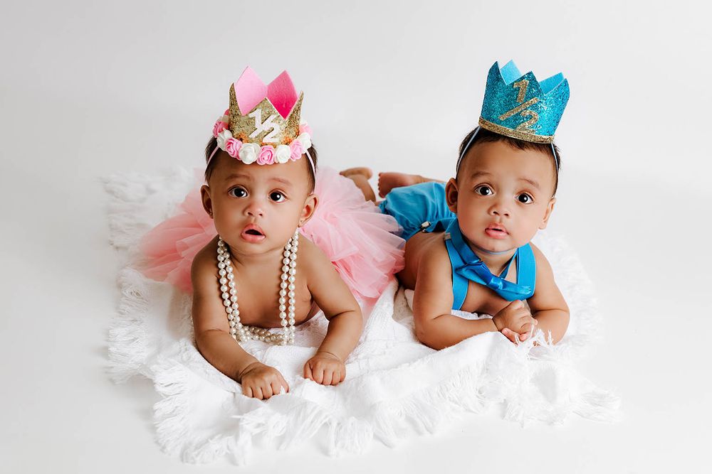 Two adorable babies wearing colorful crowns and tutus posing together by Temescal Valley twin baby photographer.