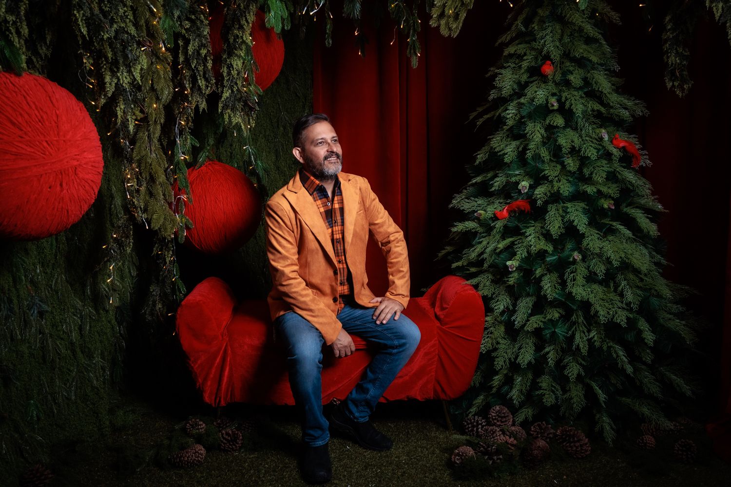 Festive red background with text 'It's Coming' surrounded by poinsettias and golden stars.