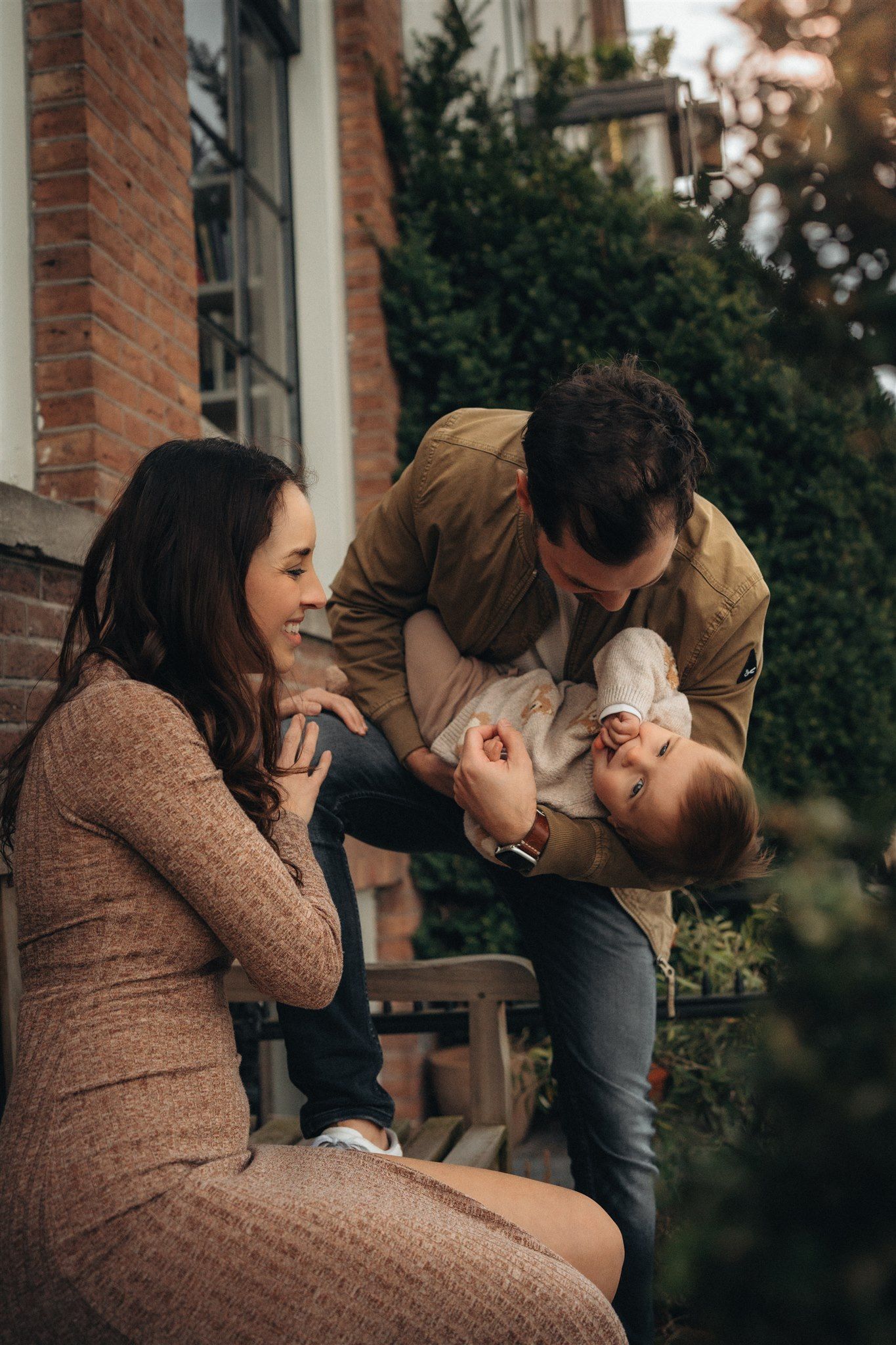 Man and women playing with their kid