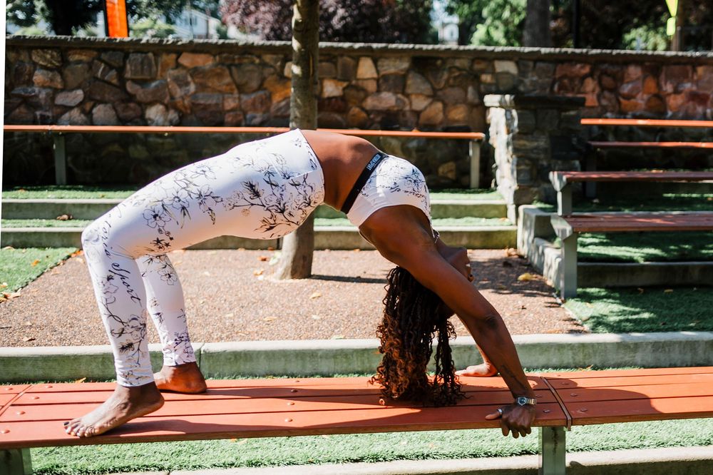 Series of yoga poses performed outdoors on a wooden deck surrounded by lush greenery.