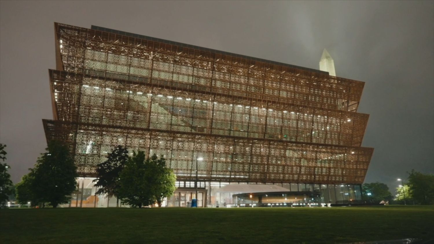 Modern architectural building illuminated at night with dramatic lighting.