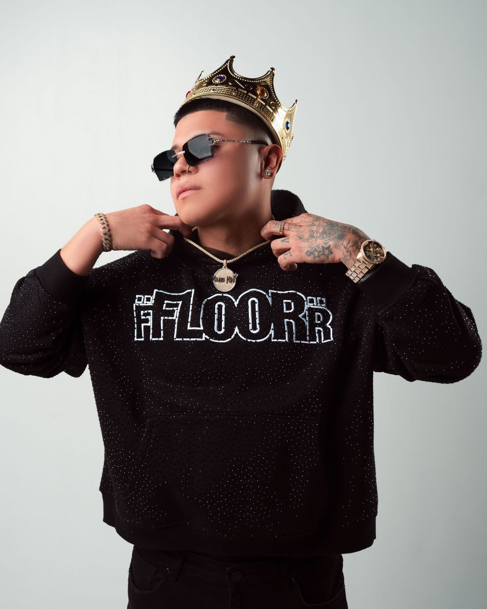 Person in black sweatshirt with text striking dramatic poses against white background in multiple shots.