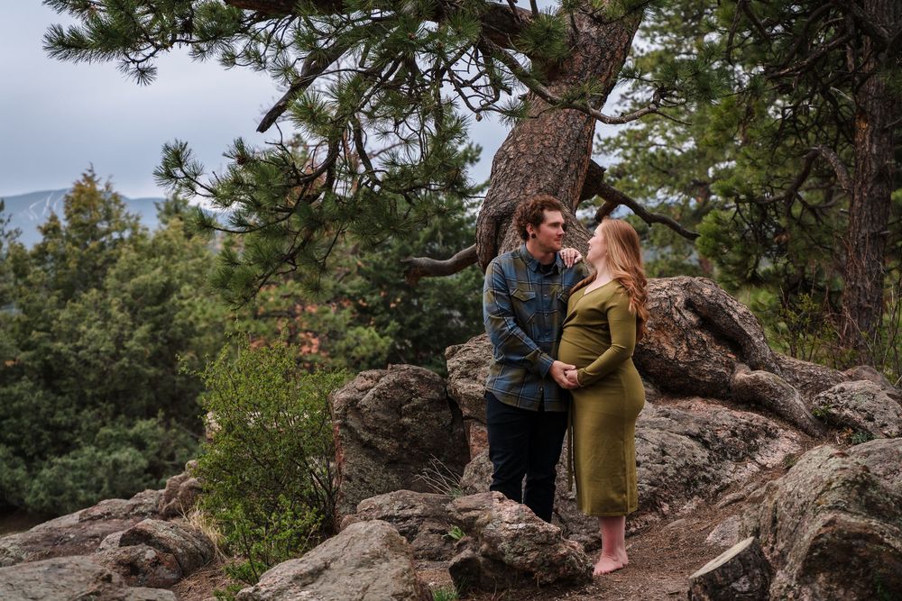 A sequence of photos showing a person and dog bonding together on rocky terrain surrounded by pine trees.