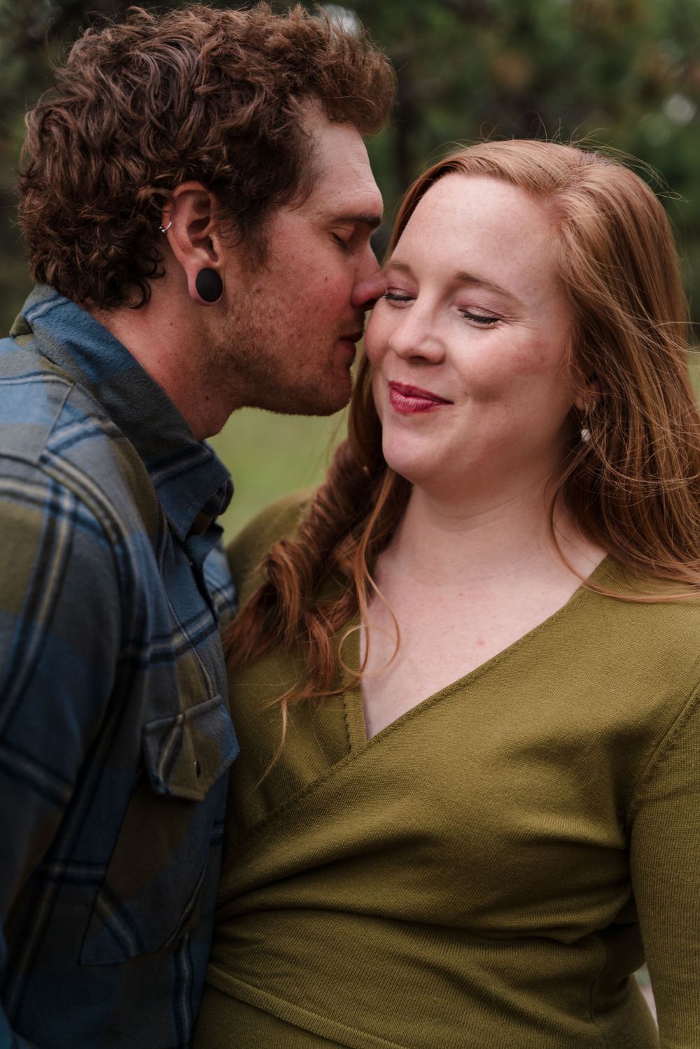 A tender romantic moment captured between a couple in natural lighting with soft expressions.