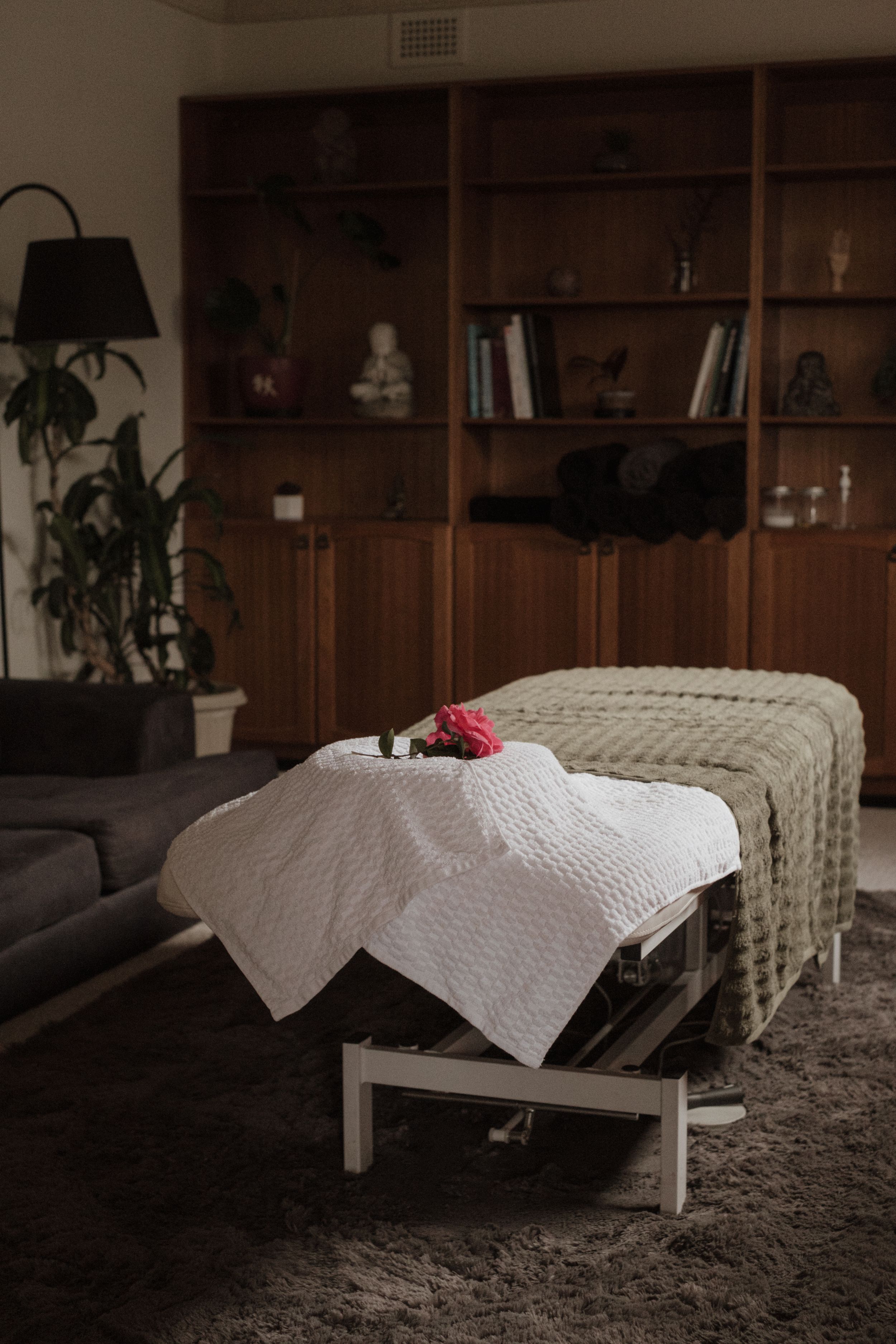 A white sheet of paper floating and falling through dark room with wooden shelves in the background.