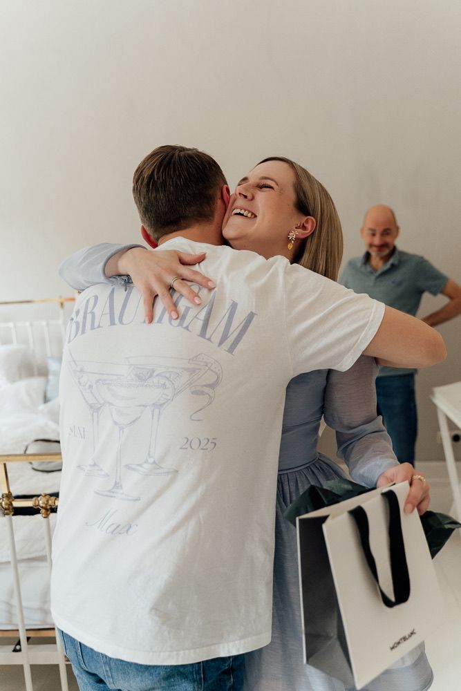A group of people in white shirts embrace each other in a series of connected photos showing emotional moments.