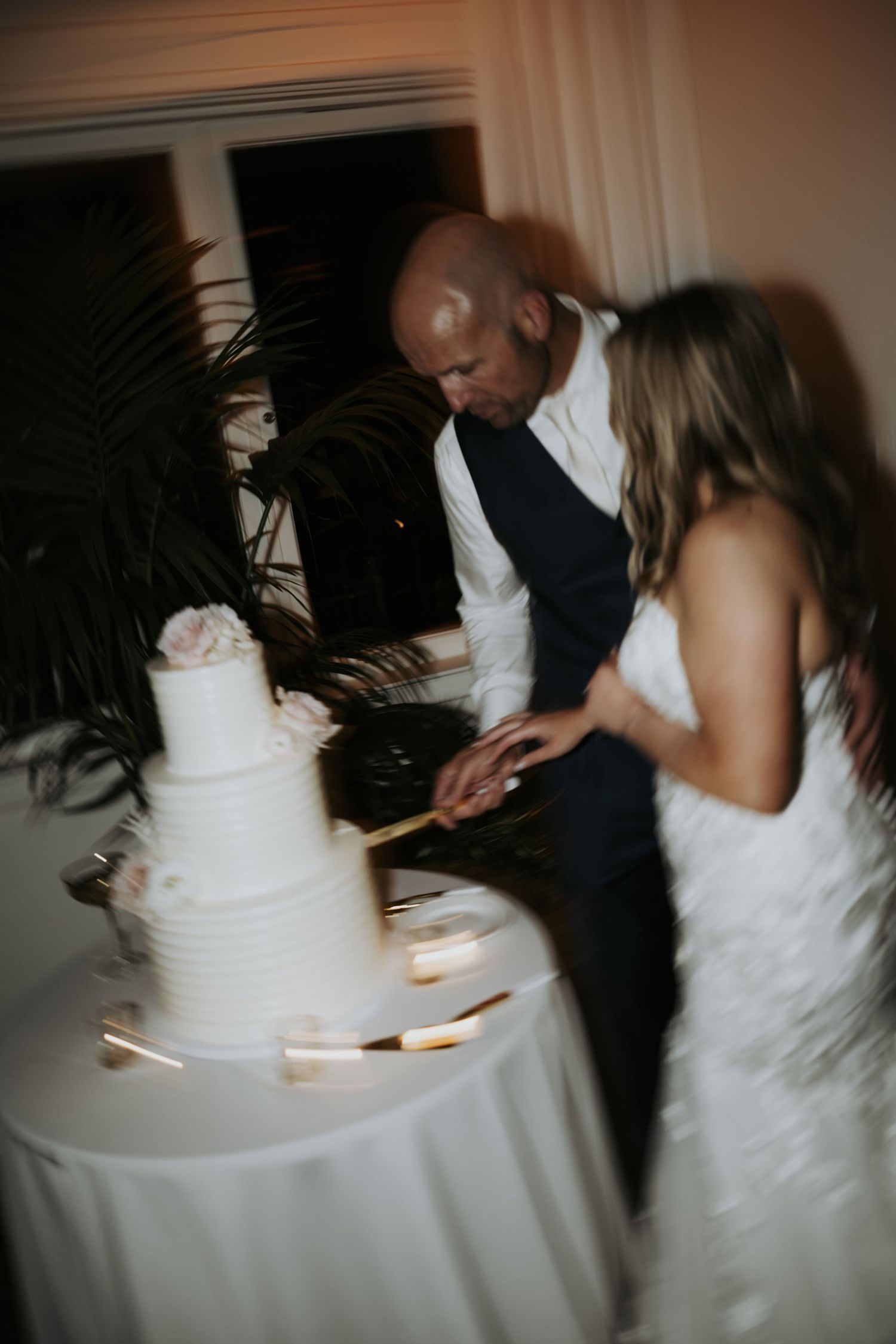 bride and groom cutting the cake