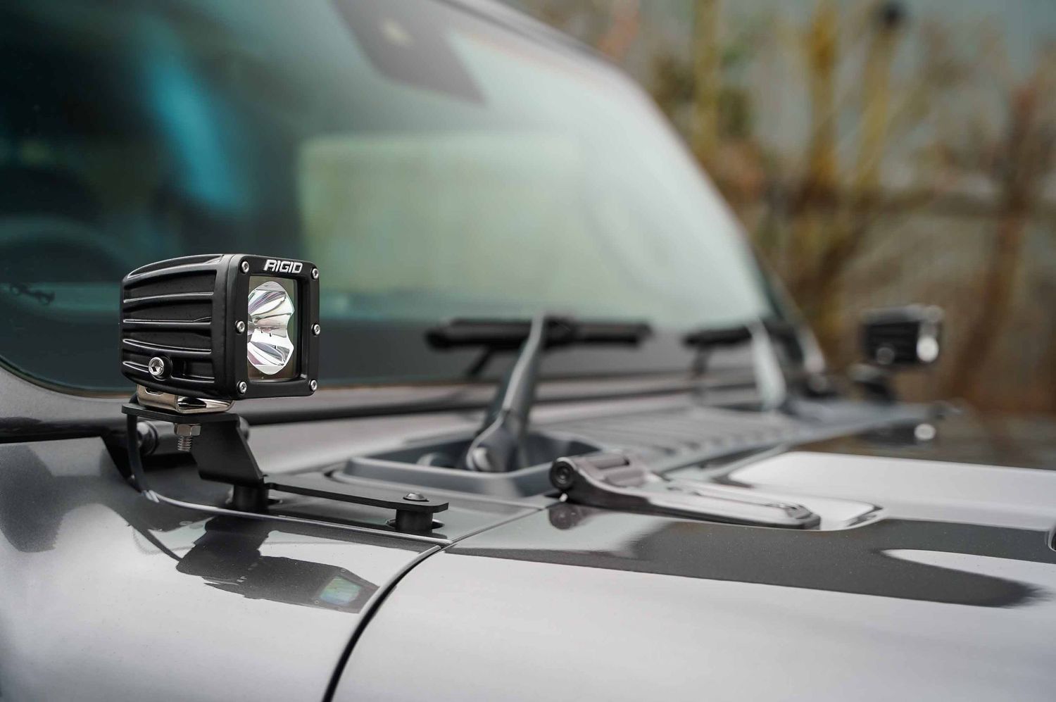 Detail shot of Jeep Wrangler windshield and hood accessories.