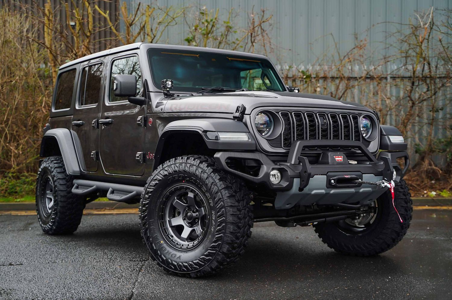 Modified Jeep Wrangler showcasing custom suspension and off-road capabilities.