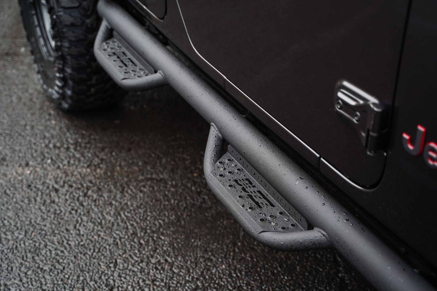 Black side steps and running boards installed on a custom off-road vehicle.