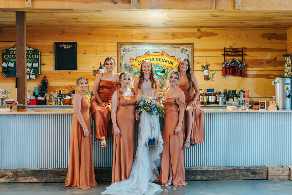 A rustic wooden venue interior with corrugated metal accents and bar area.