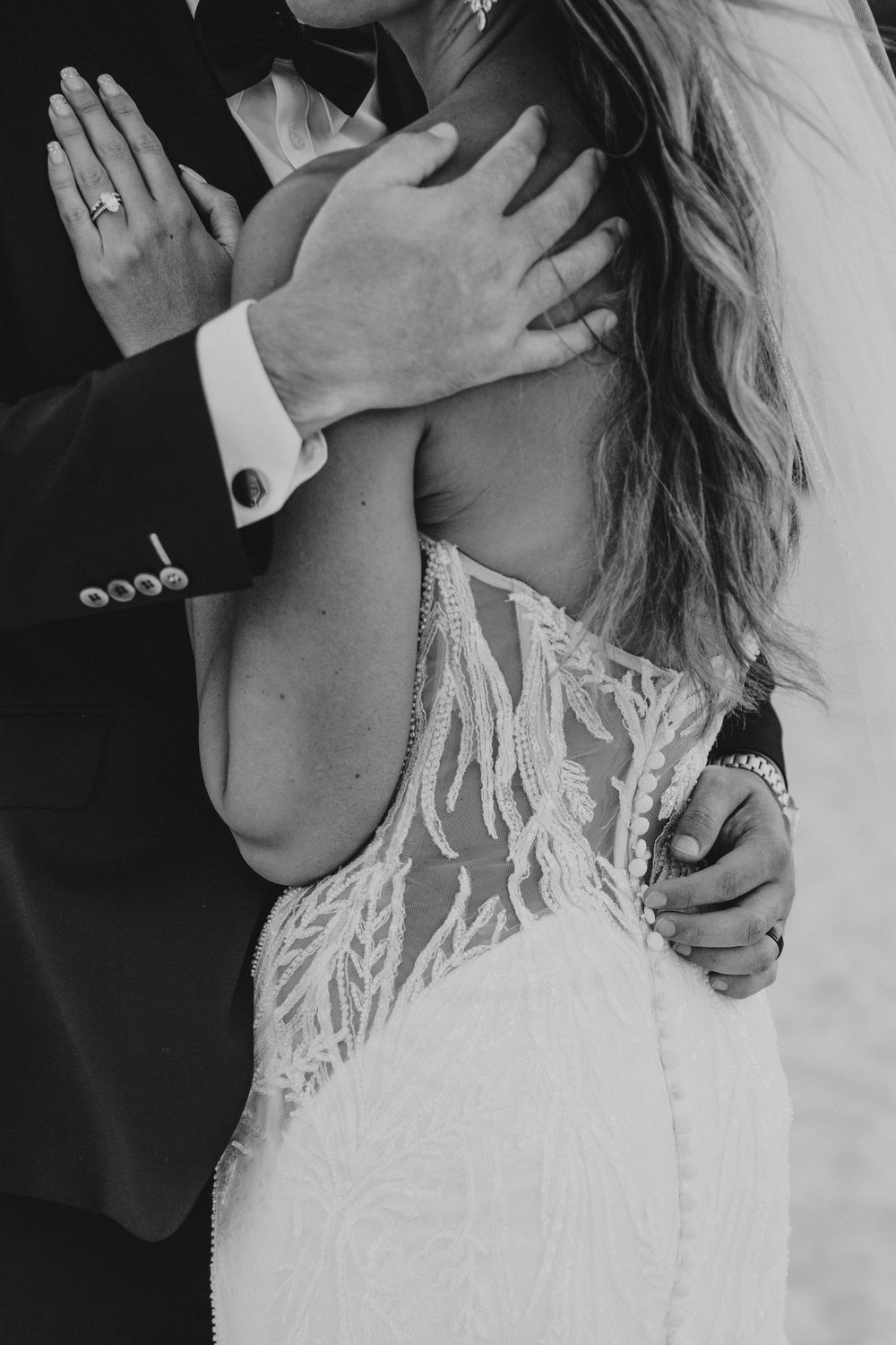 Black and white wedding photos showing romantic close-up moments between a bride and groom.