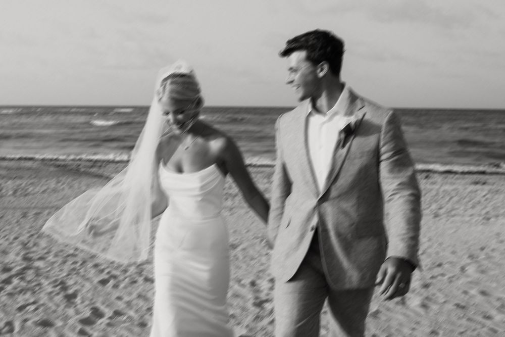 A romantic black and white photo montage of a couple embracing and walking along a beach.
