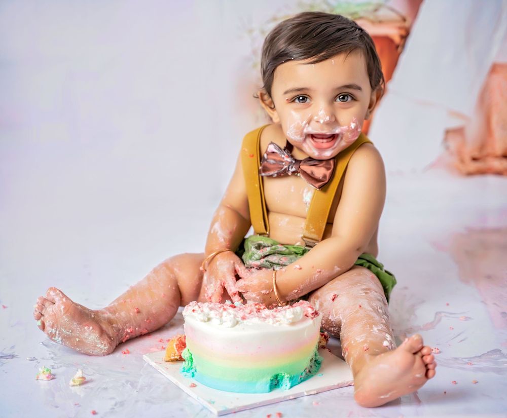 Chronological progression of a cake smash photo session showing a baby's increasing interaction with a birthday cake.