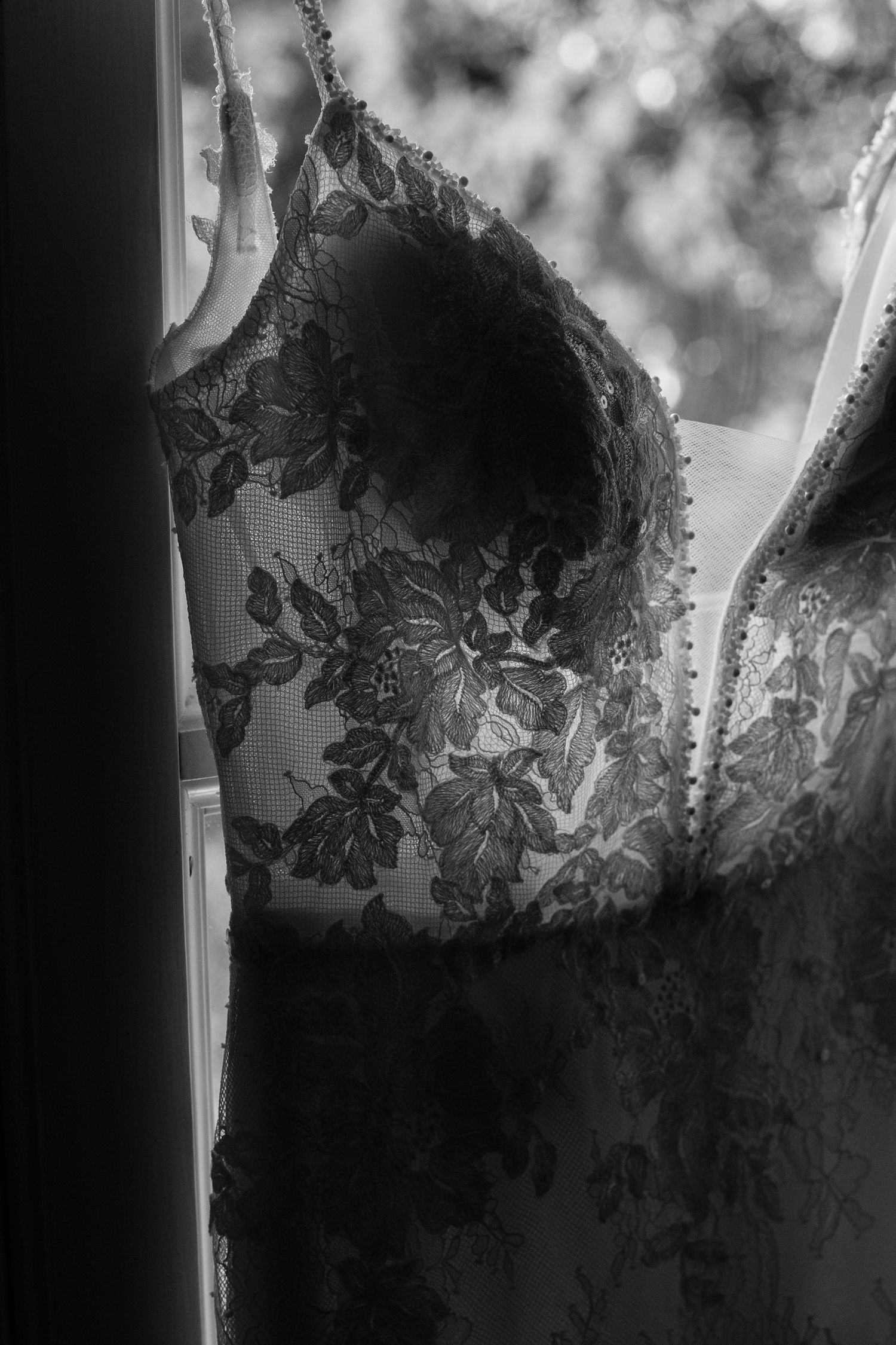 Close-up sequence of delicate black lace details and floral embellishments in monochromatic tones.